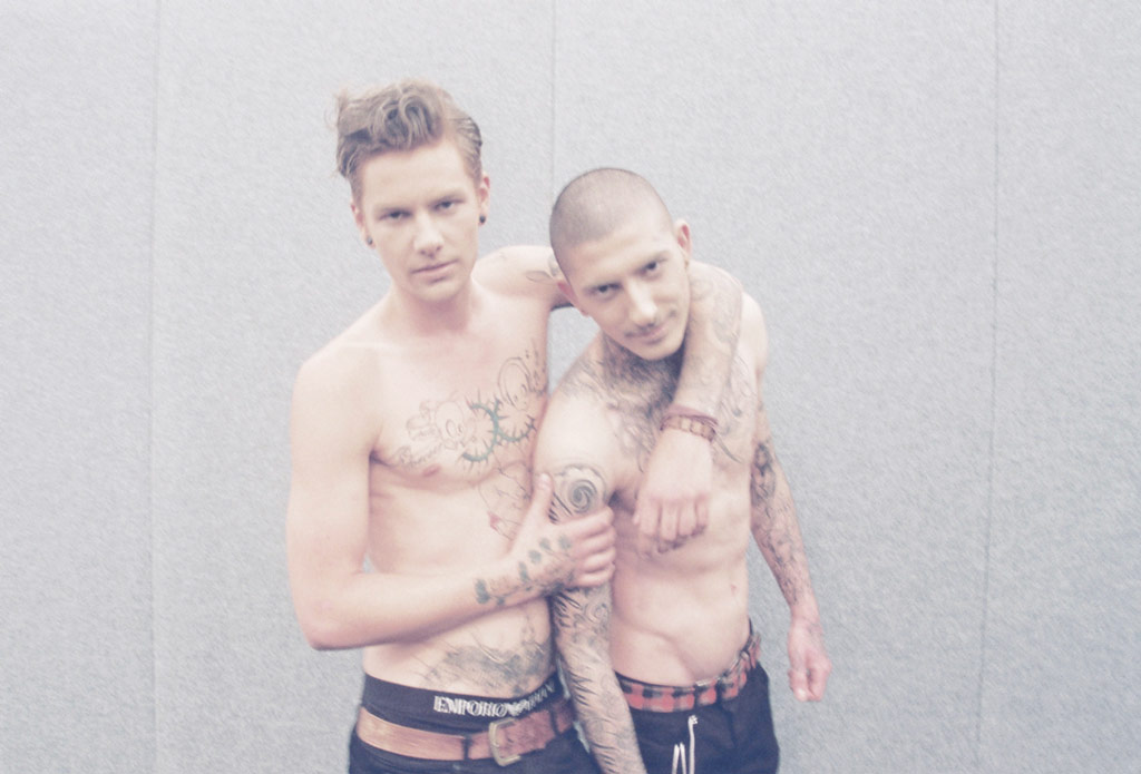 Two guys with tattoos and no shirts