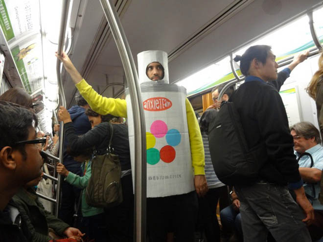 Jon riding the subway in New York City, dressed as a spray paint can