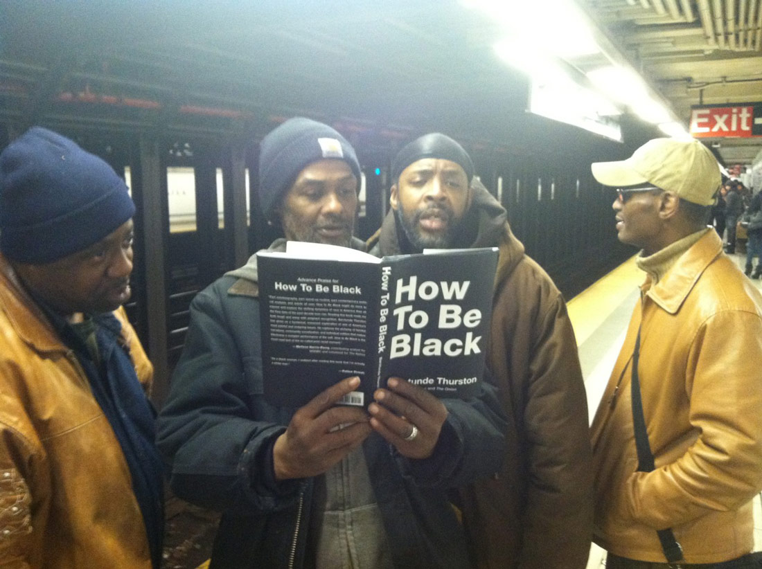 Reading How To Be Black on the subway platform