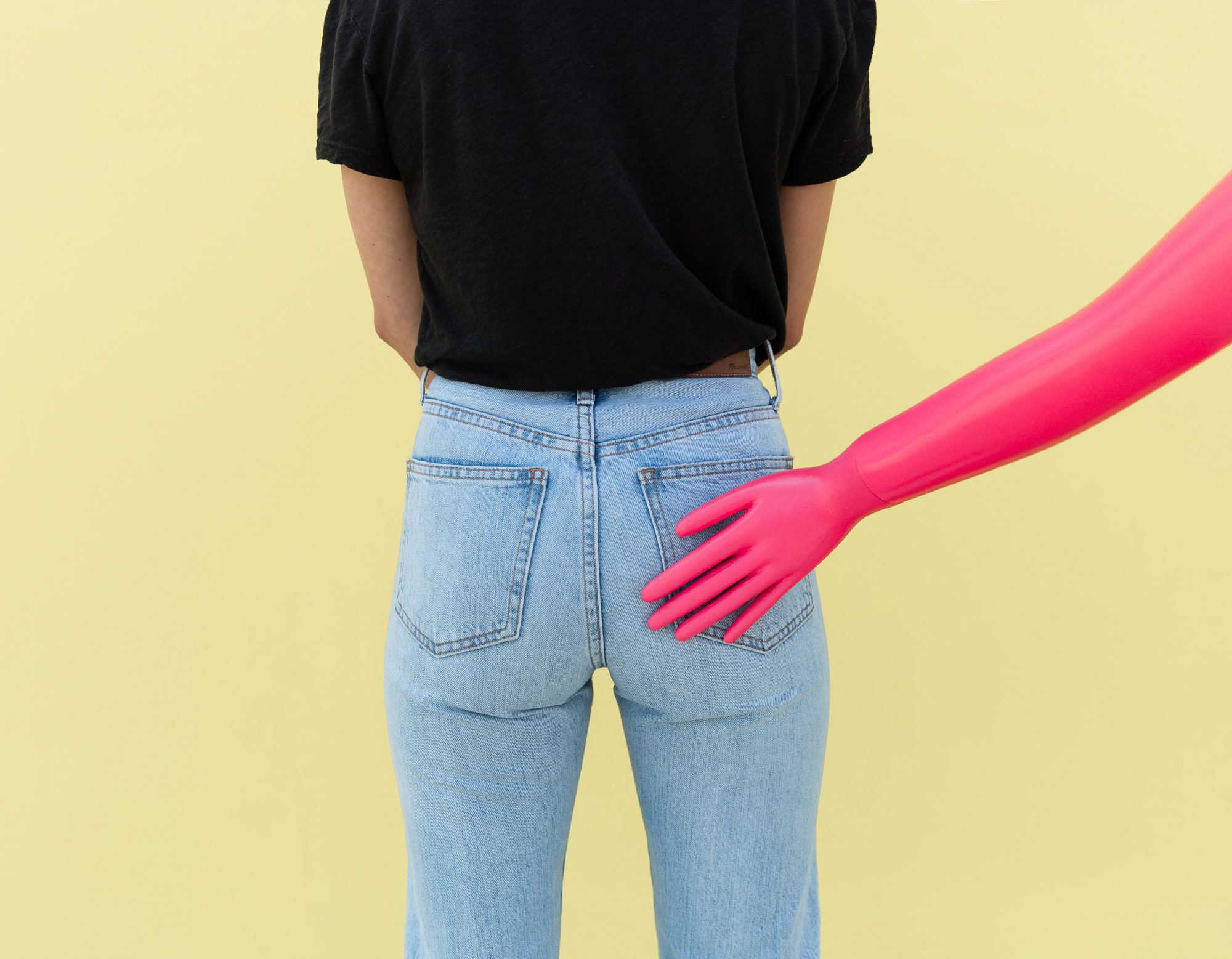 plastic hand on a woman's butt