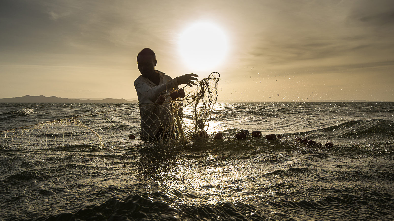 A fisherman sets his nets in Lake Turkana
