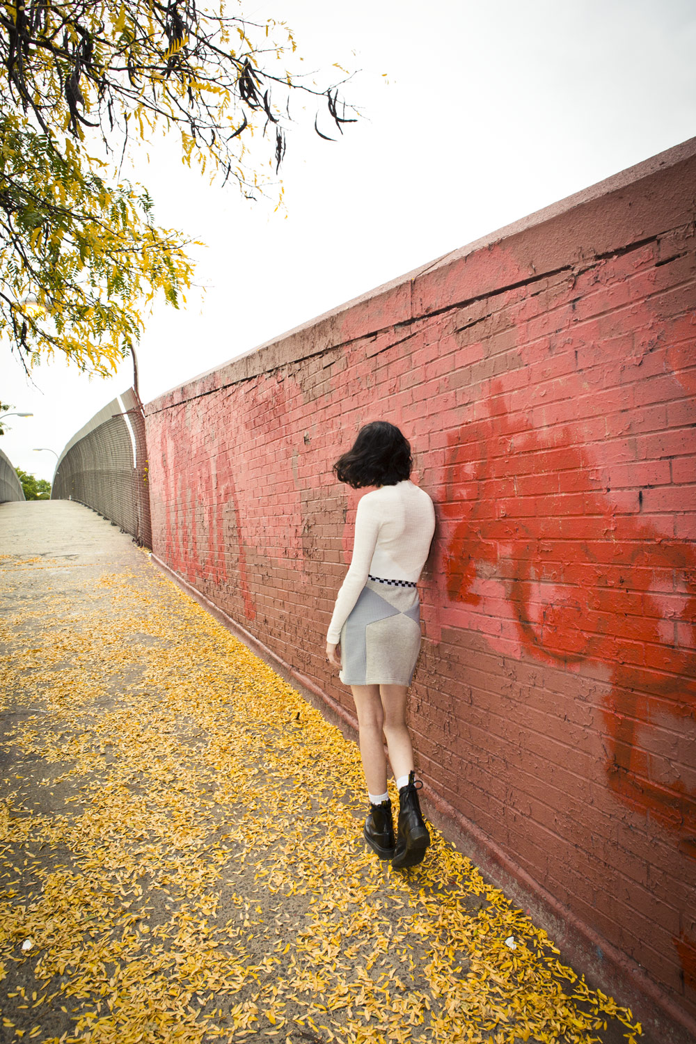 girl against red wall