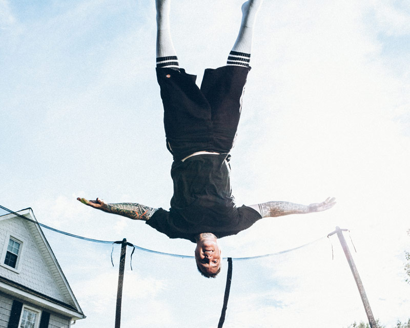 Joshua Davis upsidedown on a trampoline